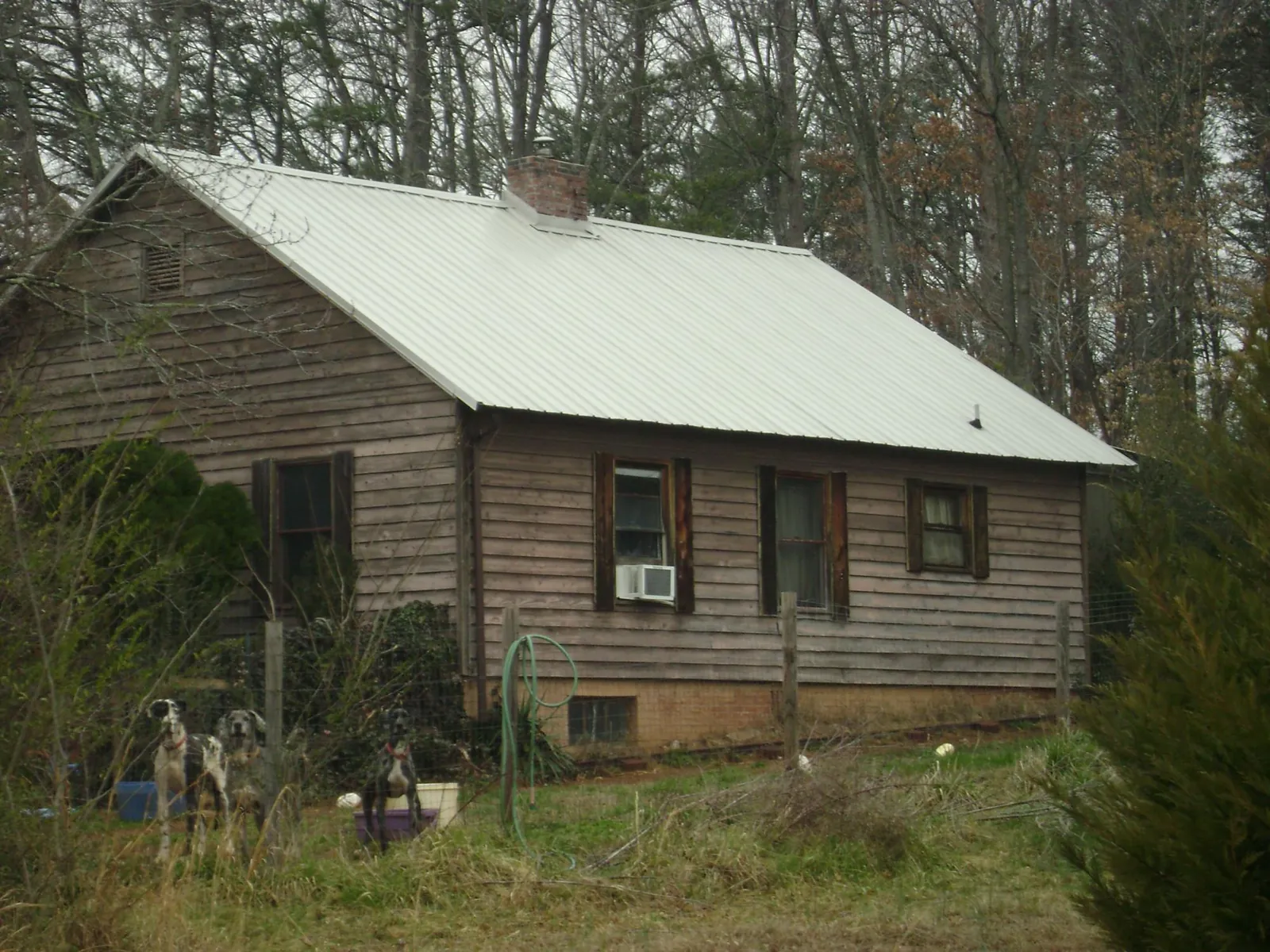 White metal roof on an old wood sided farmhouse, from a Metal Roof Installation job in Waucoma